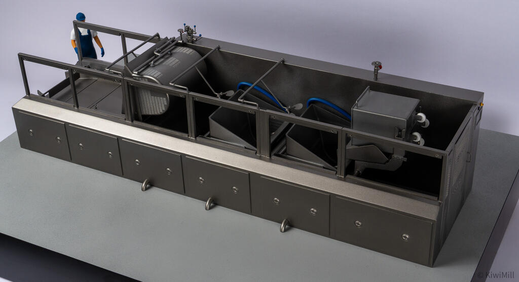 Elevated view into the open cooking line model, showing the cooking basket, two chutes and the tote bin lift